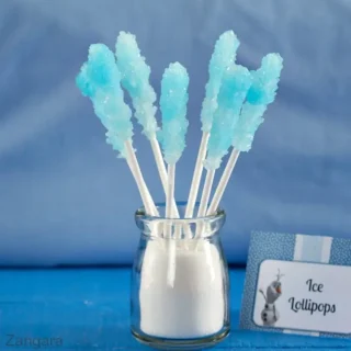 Blue rock candy lollipops displayed in a jar beside a Frozen-themed label.
