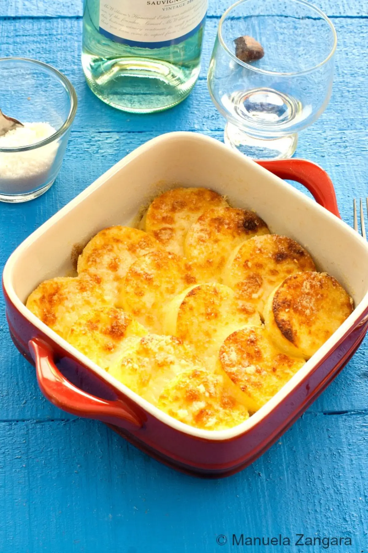 Baked gnocchi alla Romana in a ceramic dish, golden on top.