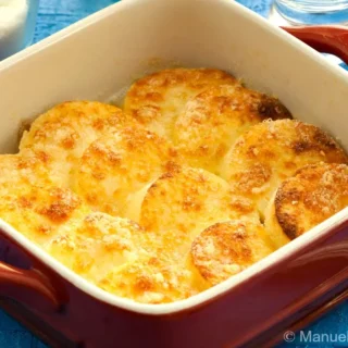 Close-up of golden baked gnocchi alla Romana in baking dish.