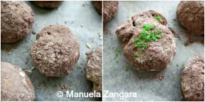 Close-up of cookies rolled in cocoa sugar, one decorated with green sugar moss.
