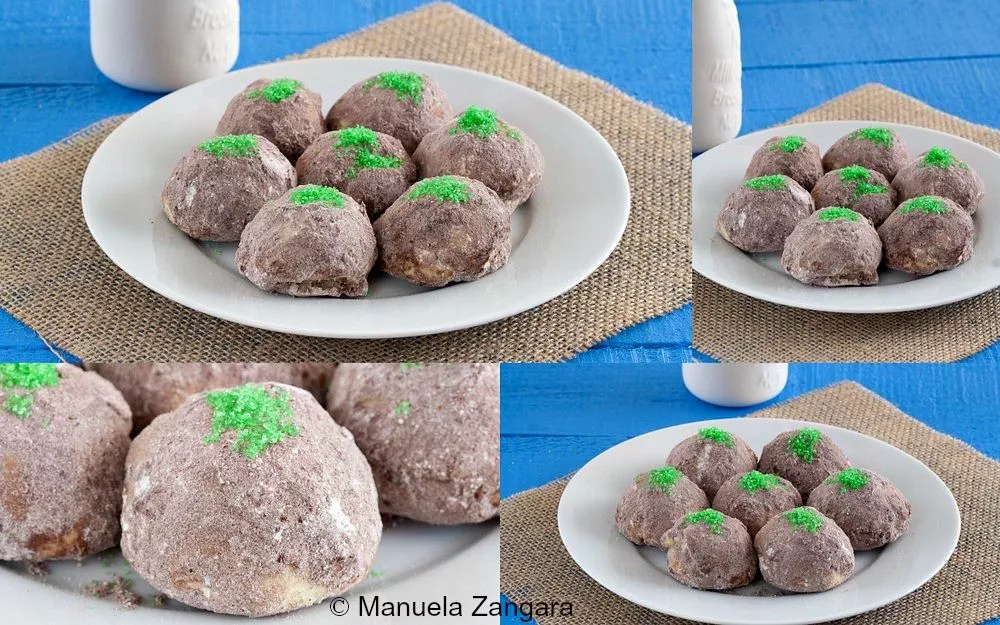 Plate of finished Troll Cookies coated in cocoa sugar with green moss decoration.