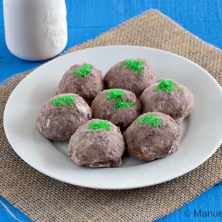 Plate of Troll Cookies arranged together, coated in cocoa sugar with green sugar moss.