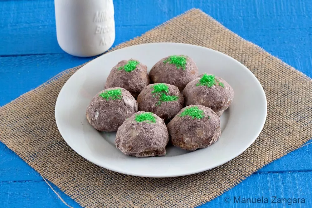 Plate of Troll Cookies arranged together, coated in cocoa sugar with green sugar moss.