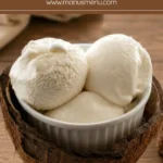Coconut ice cream served in a bowl nestled inside a fresh coconut shell.