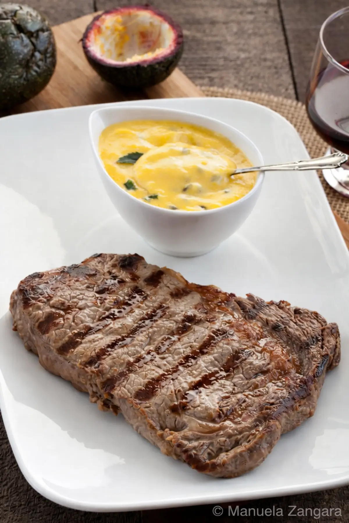 Grilled steak served with passion fruit Béarnaise sauce in a small bowl.