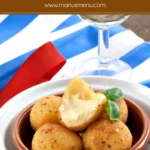 Close-up of fried cheese bitterballen with crisp coating.