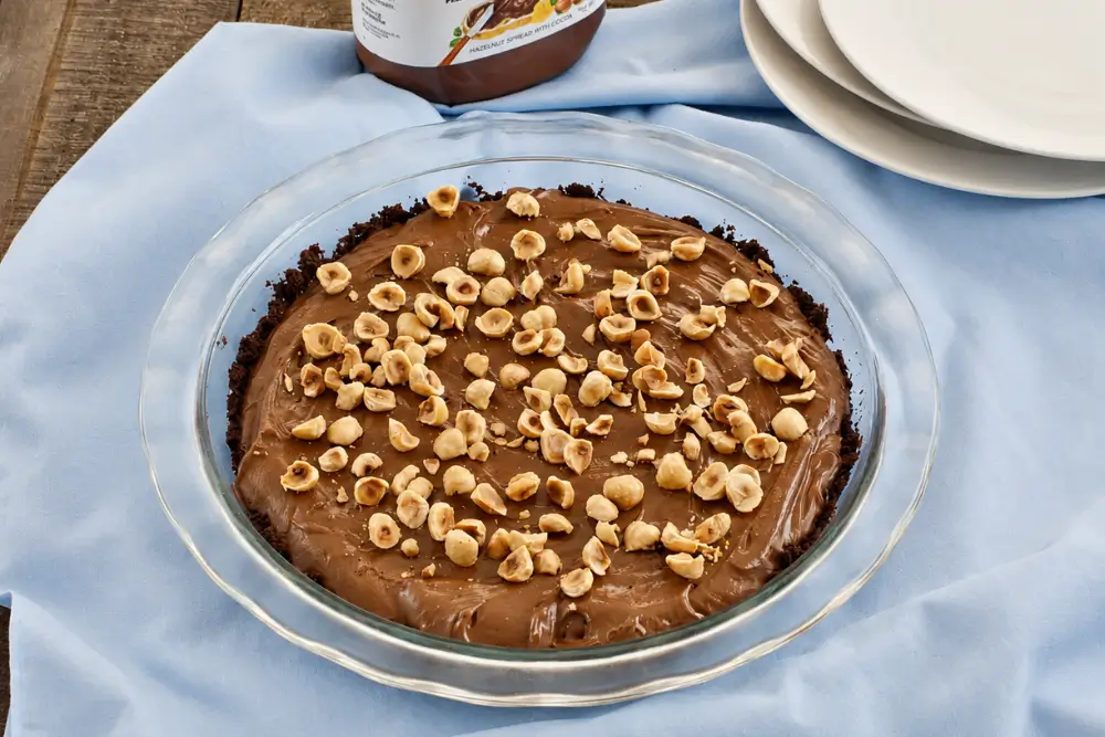 Chilled chocolate hazelnut pie topped with chopped toasted hazelnuts.