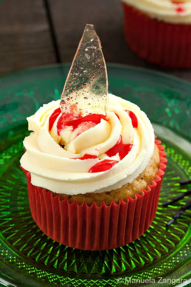 Bloody broken glass cupcake topped with sugar glass shard and strawberry syrup drizzle.