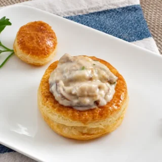 Mushroom Vol au Vents served on a white plate with parsley garnish.
