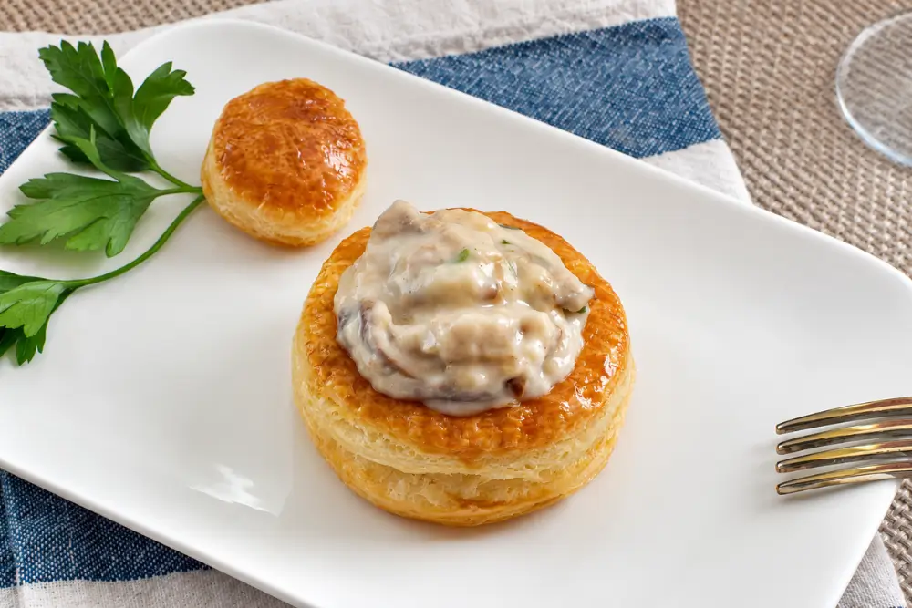 Mushroom Vol au Vents served on a white plate with parsley garnish.