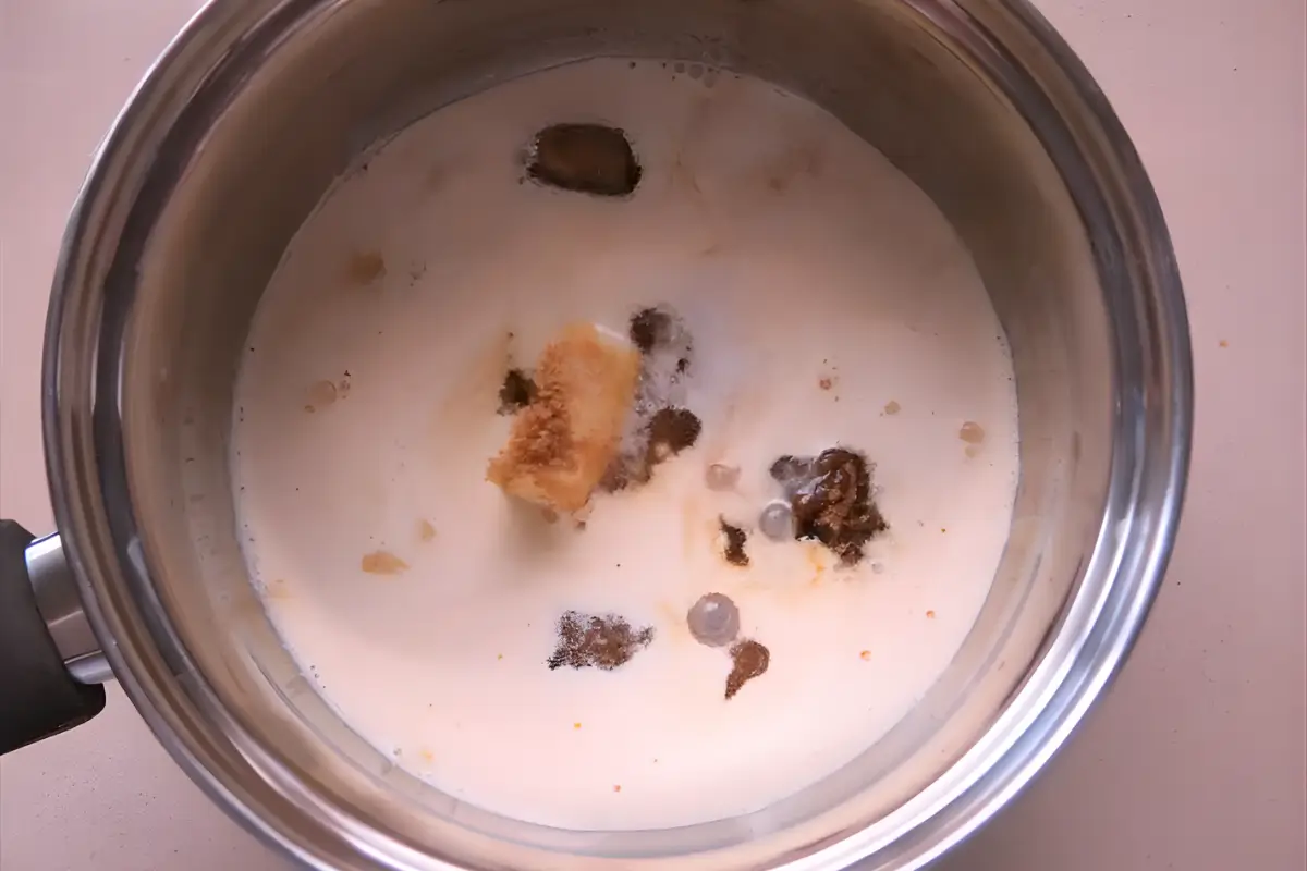 Butter, sugar, and cream in a saucepan before cooking butterscotch sauce.