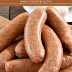 Uncooked pork sausages with mozzarella and Sun-Dried tomatoes on a wooden board.