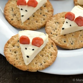 Cheese Mouse on a Cracker arranged on a white serving plate.