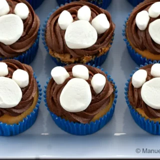 Paw print cupcakes arranged on a serving plate.
