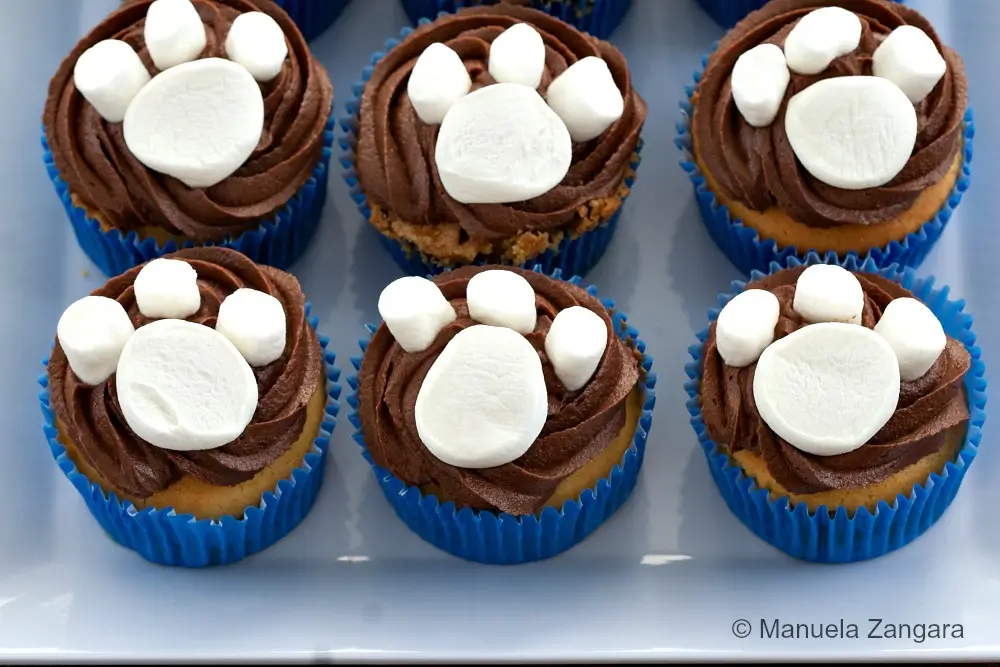 Paw print cupcakes arranged on a serving plate.