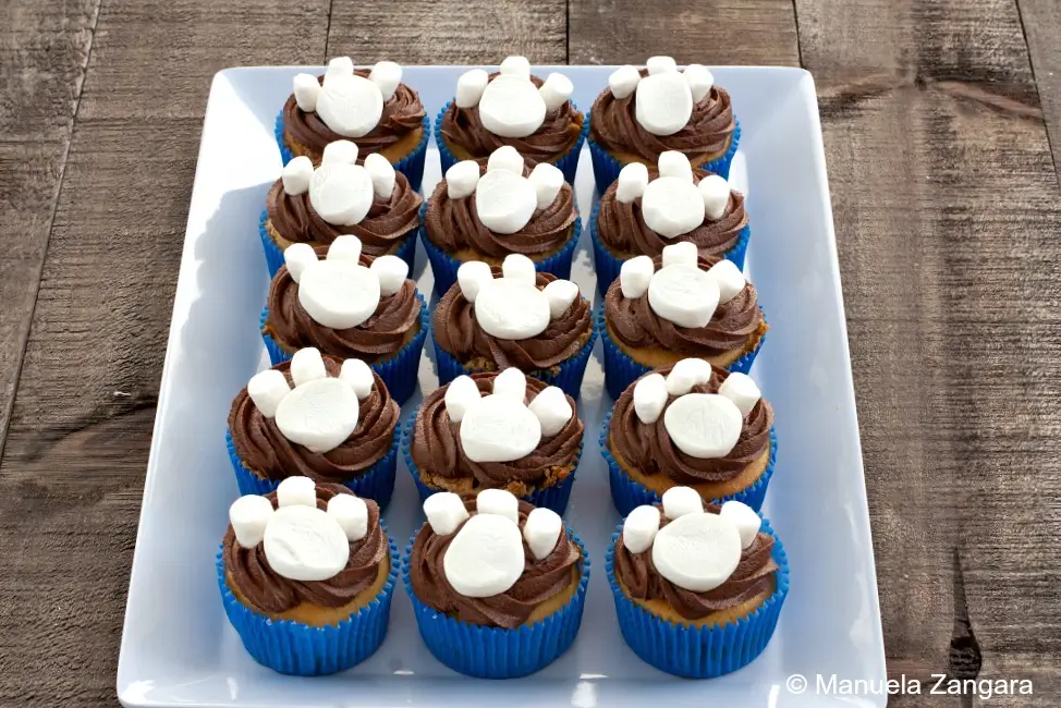 Paw print cupcakes with Nutella icing and marshmallow paws arranged on a serving plate.