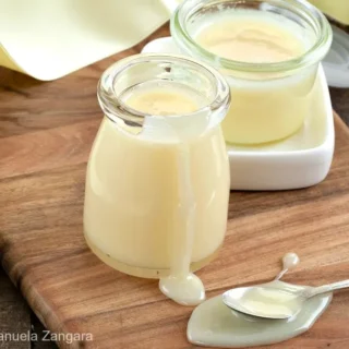 Close-up of homemade condensed milk in a glass jar.