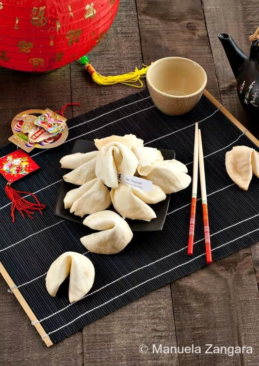 Homemade fortune cookies on a bamboo mat.