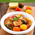 Lemon Halloumi Salad with cherry tomatoes and basil served in a white bowl.