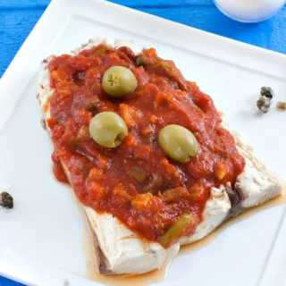Close-up of Mahi Mahi covered with rich caponata sauce.