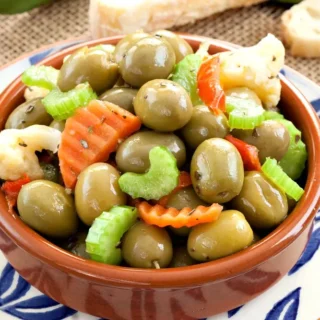 Close-up of Olive Schiacciate with green olives and chopped pickled vegetables.