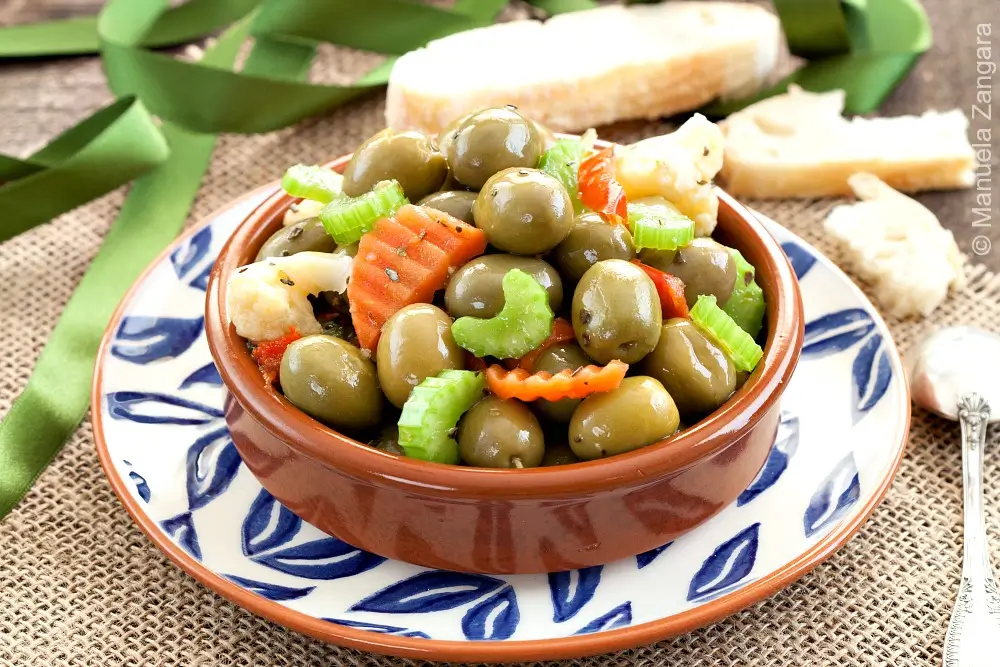 Cracked olive salad with vegetables in a small serving bowl.