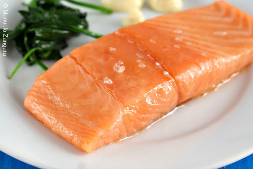 Close-up of gently cooked salmon with soft, glossy texture.
