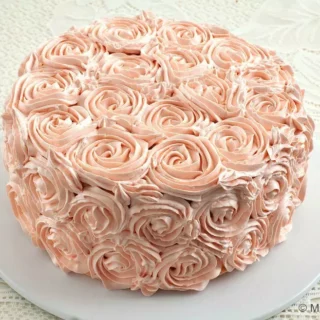Whole rosette cake covered in pale pink buttercream roses.