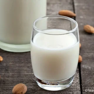 Close-up of Sicilian Almond Milk in a glass after straining.