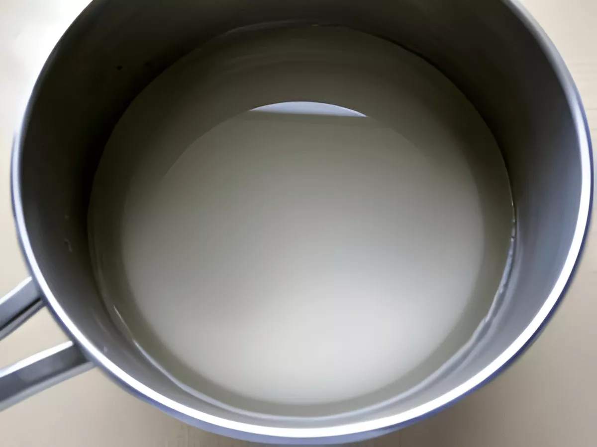 Saucepan with clear sugar syrup.