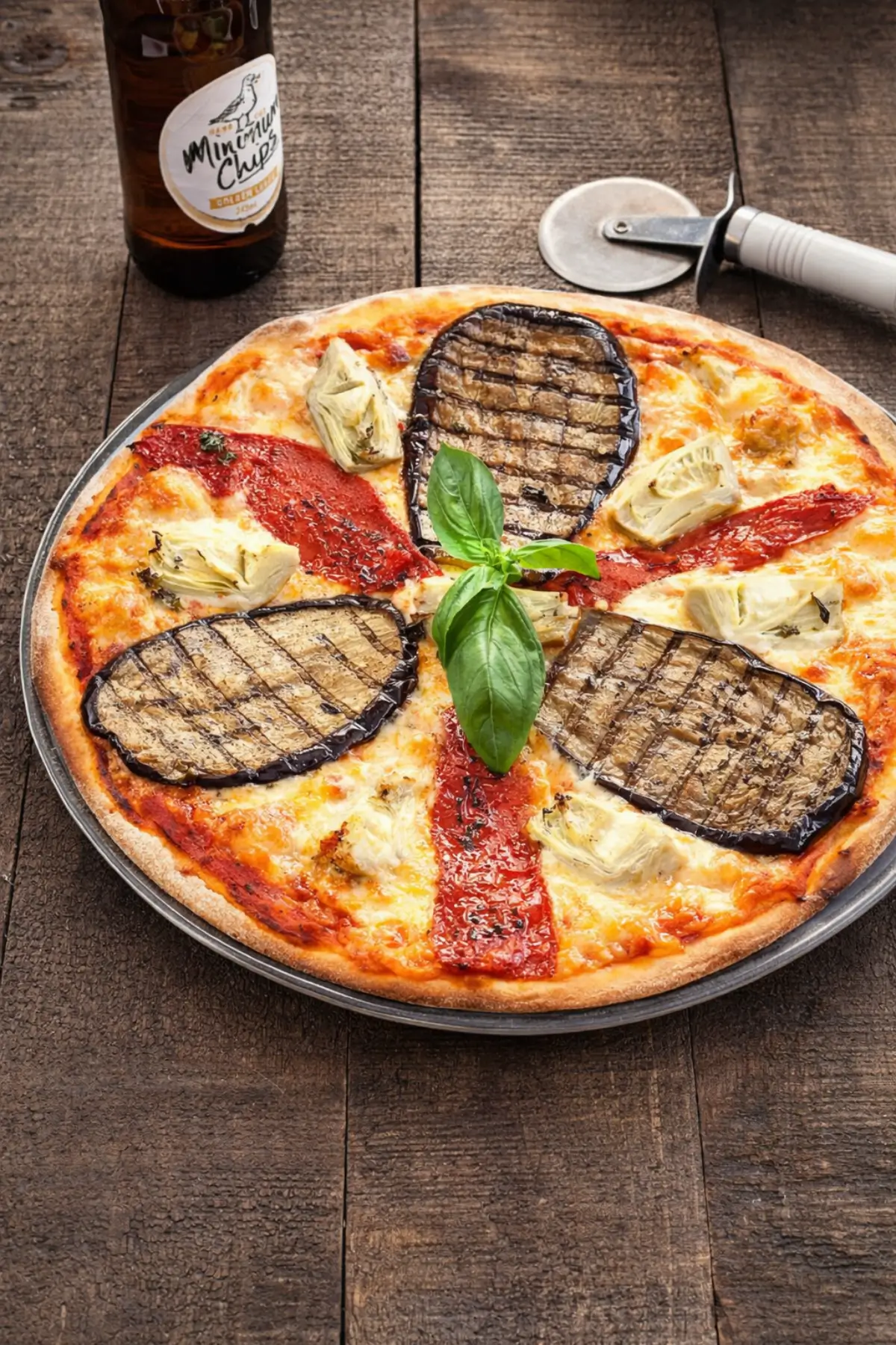 Freshly baked pizza ortolana topped with grilled eggplant, roasted peppers, artichokes, melted mozzarella, and fresh basil.