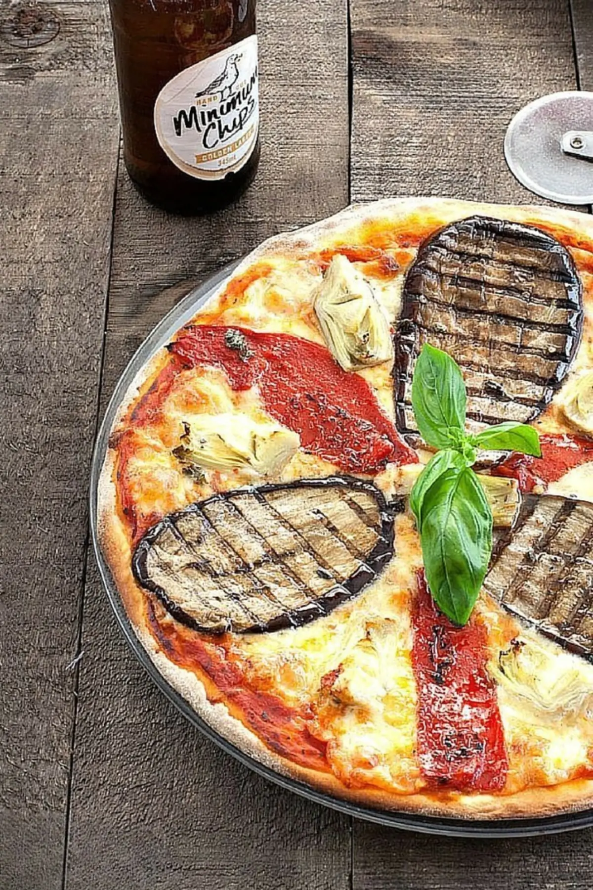 Pizza Ortolana topped with grilled eggplant, roasted red peppers, and artichoke hearts.