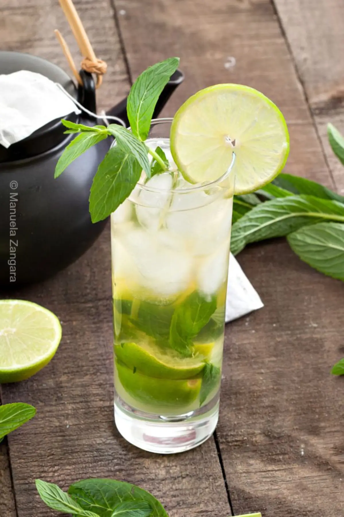 Iced mojito-style drink with lime wedges, fresh mint, and chilled green tea.