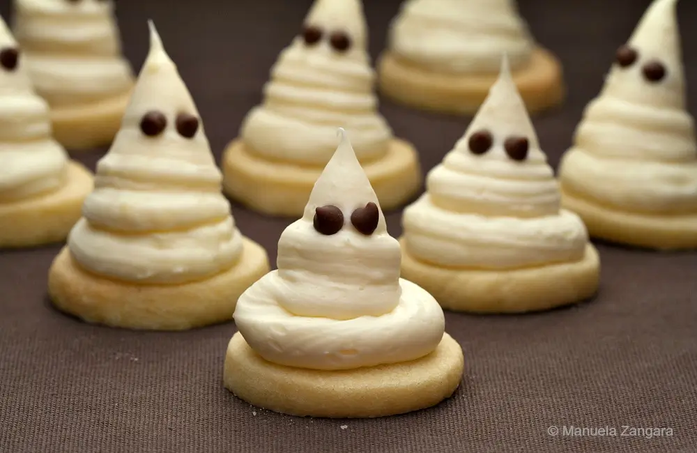 Close-up of a single Halloween cookie with chocolate chip eyes.