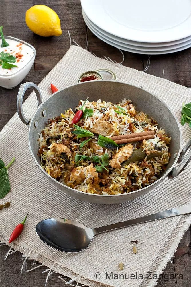 Hyderabadi Chicken Biryani served with boiled eggs, caramelised onions, and nuts.