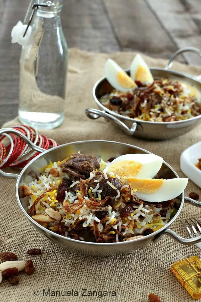 Mughlai Lamb Biryani with aromatic spices and garnished with fried onions.