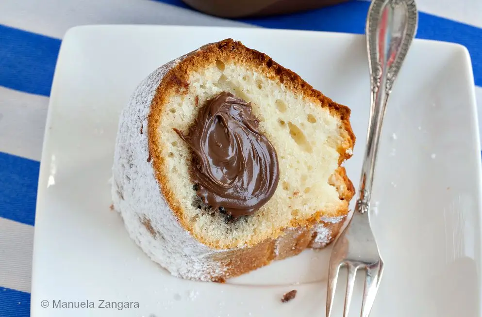 Slice of cake showing the soft crumb and creamy Nutella centre.