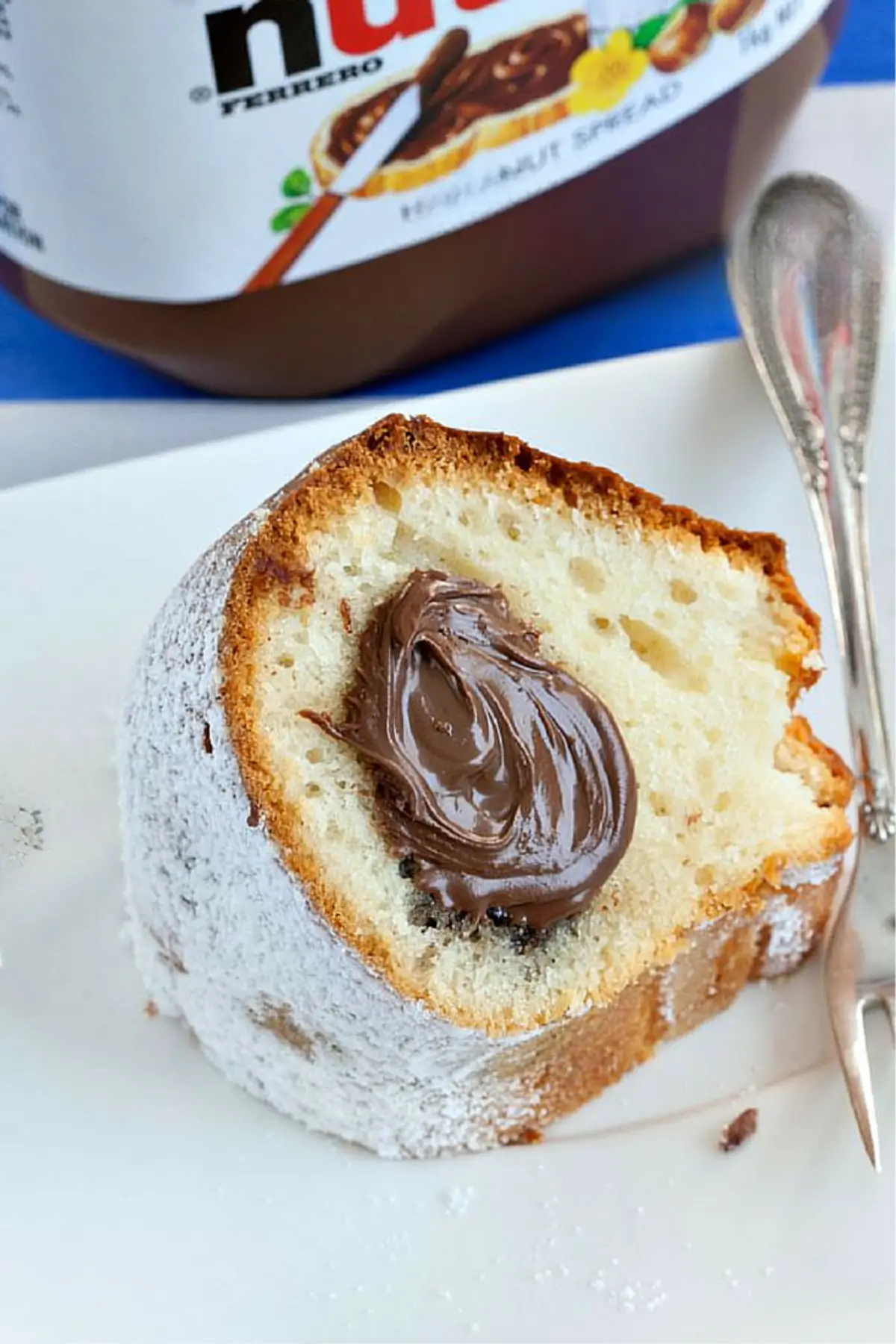 Slice of yoghurt cake with a smooth Nutella centre on a plate.