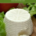 Goat’s milk ricotta with a small spoonful removed to show texture.