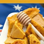 "Honeycomb pieces arranged on a white plate with an Australian flag behind them.