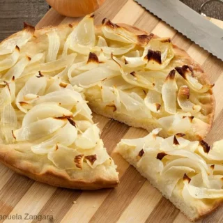 Close-up of sliced Onion Schiacciata showing soft crumb and caramelised onions.