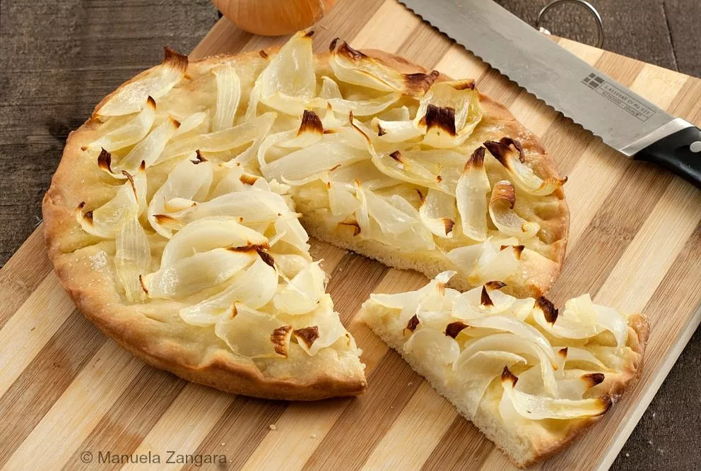 Close-up of sliced Onion Schiacciata showing soft crumb and caramelised onions.