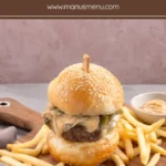 Beef burger served with fries and a small bowl of Cajun mayo.