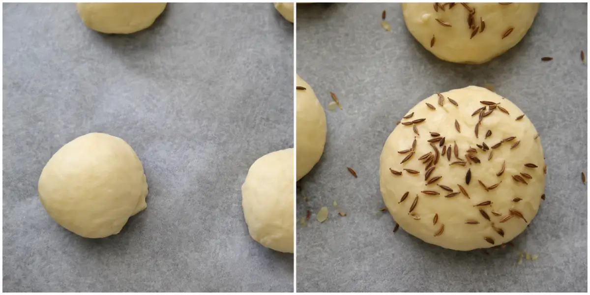 Shaped homemade burger buns brushed with egg and sprinkled with sesame seeds.