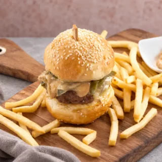 Cajun burger assembled with creamy mayo, melted cheese and vegetables.