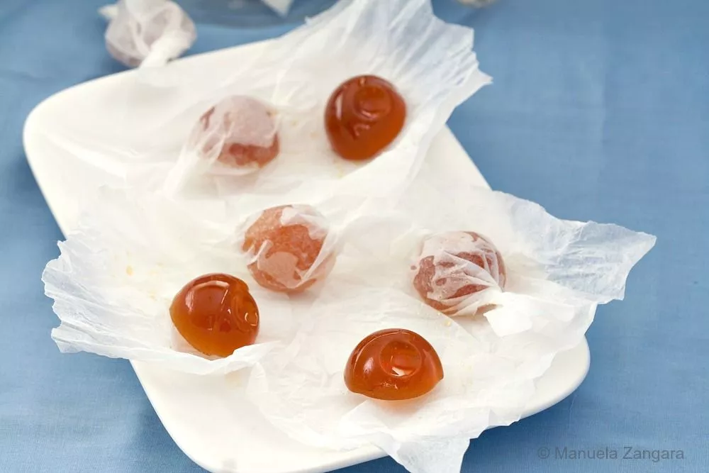 Homemade honey hard candies cooling in silicone moulds.