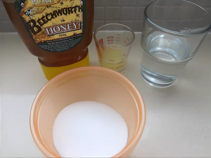 Honey, sugar, water, and lemon juice ingredients prepared for caramel mixture.
