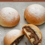 Baked Nutella Iris dusted with icing sugar and filled with creamy chocolate hazelnut spread.