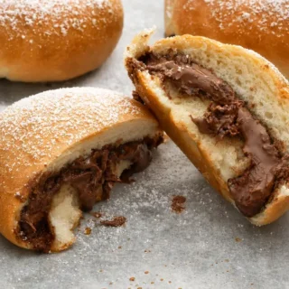 Baked Nutella Iris dusted with icing sugar and filled with creamy chocolate hazelnut spread.