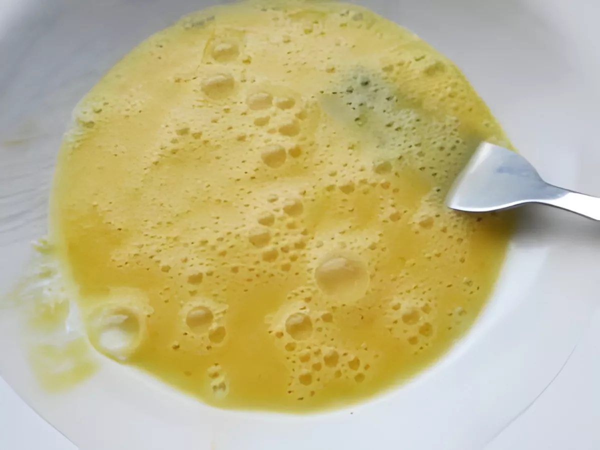 A bowl of lightly beaten eggs, ready for coating Barramundi fillets.
